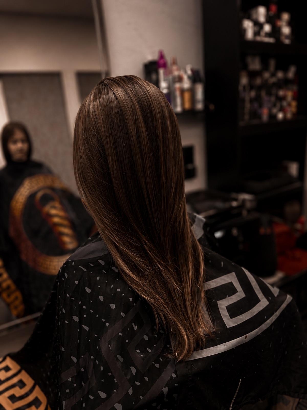 Long brunette hair with a smooth, high-shine blow-dry at Empire salon in Corby