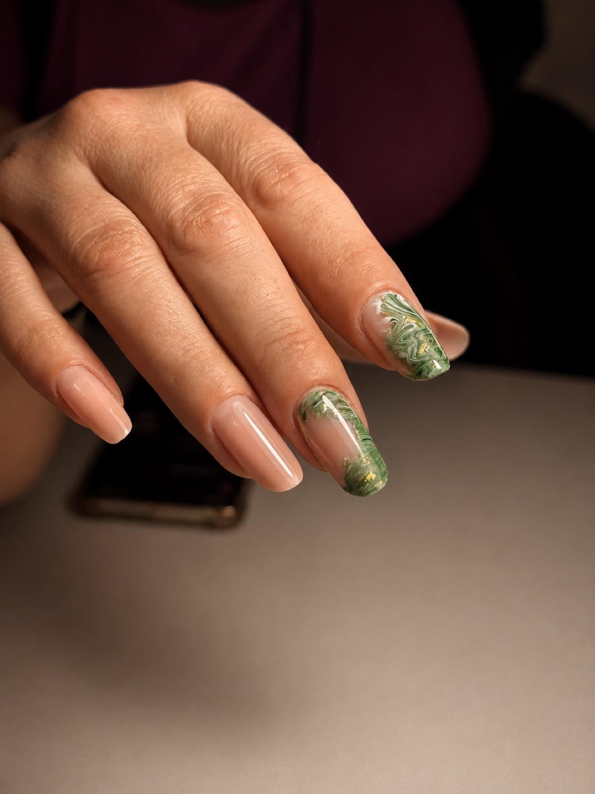 Natural nails with an emerald-green marbled accent at Empire nail salon in Corby